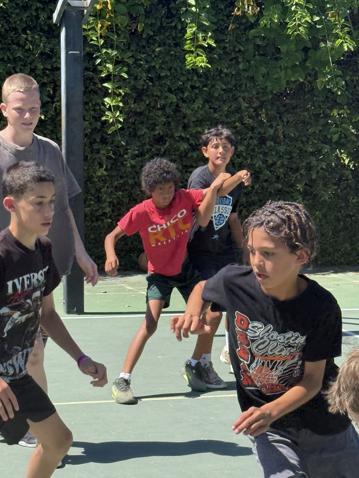 Young players working on defense at an outdoor camp