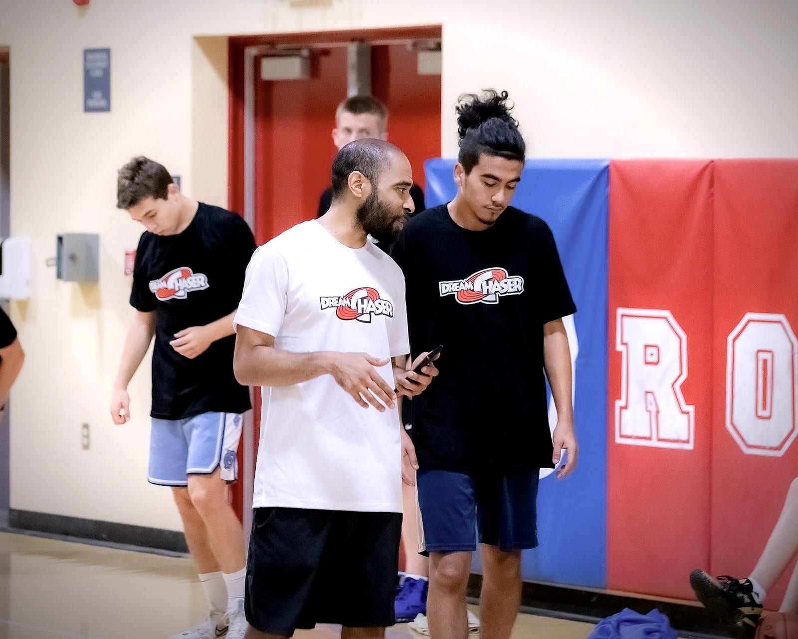 Coach Jelani Hicks giving one on one instruction to a teenage athlete