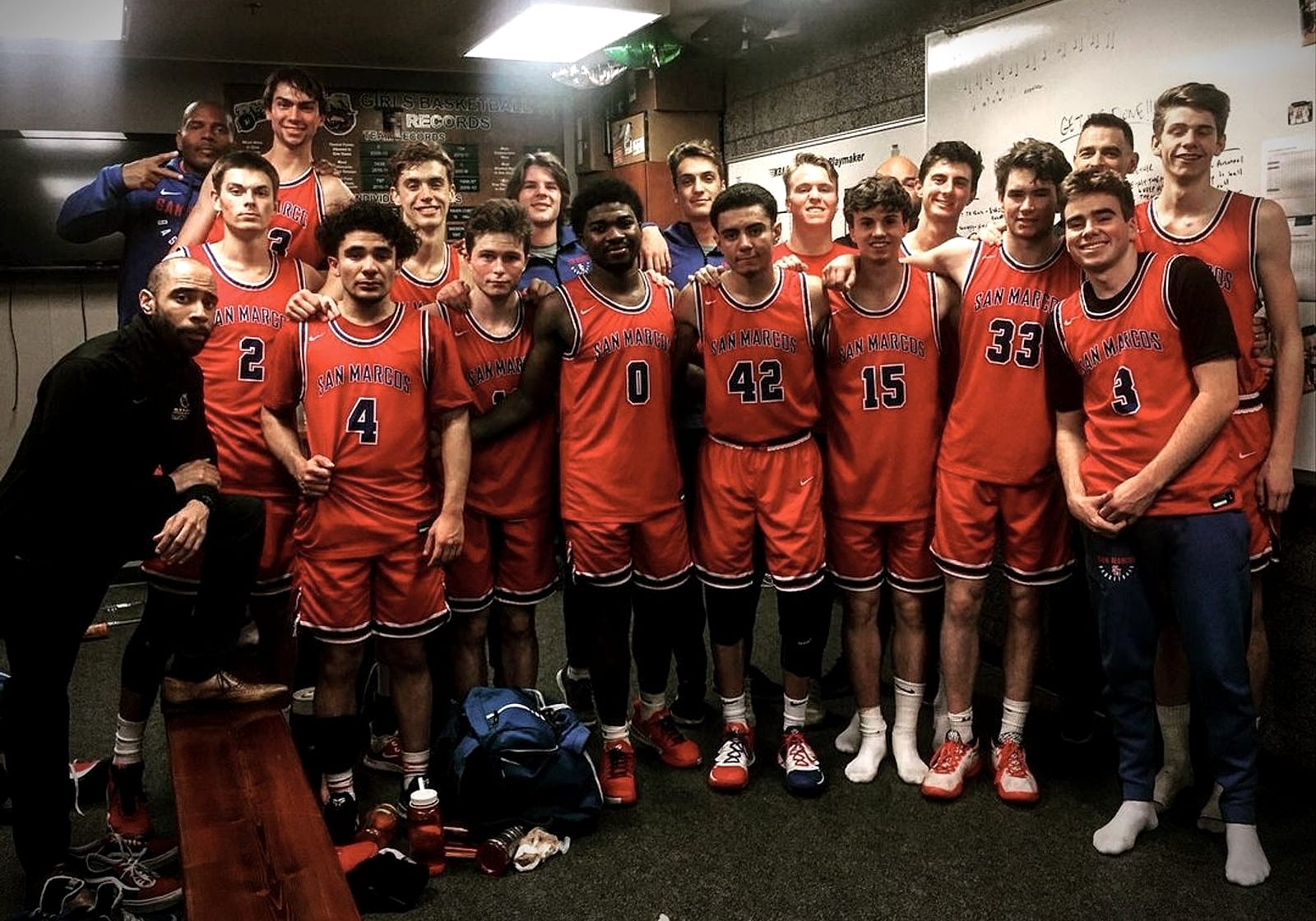 High school team coached by Jelani Hicks celebrating in the locker room