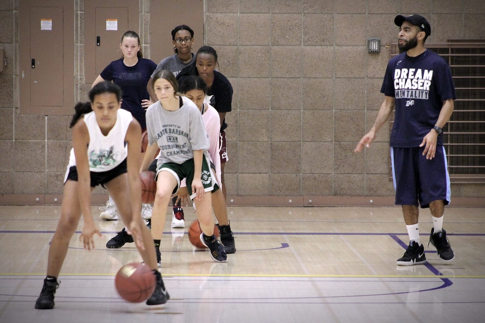 Dream Chaser athletes working through a group ball handling drill